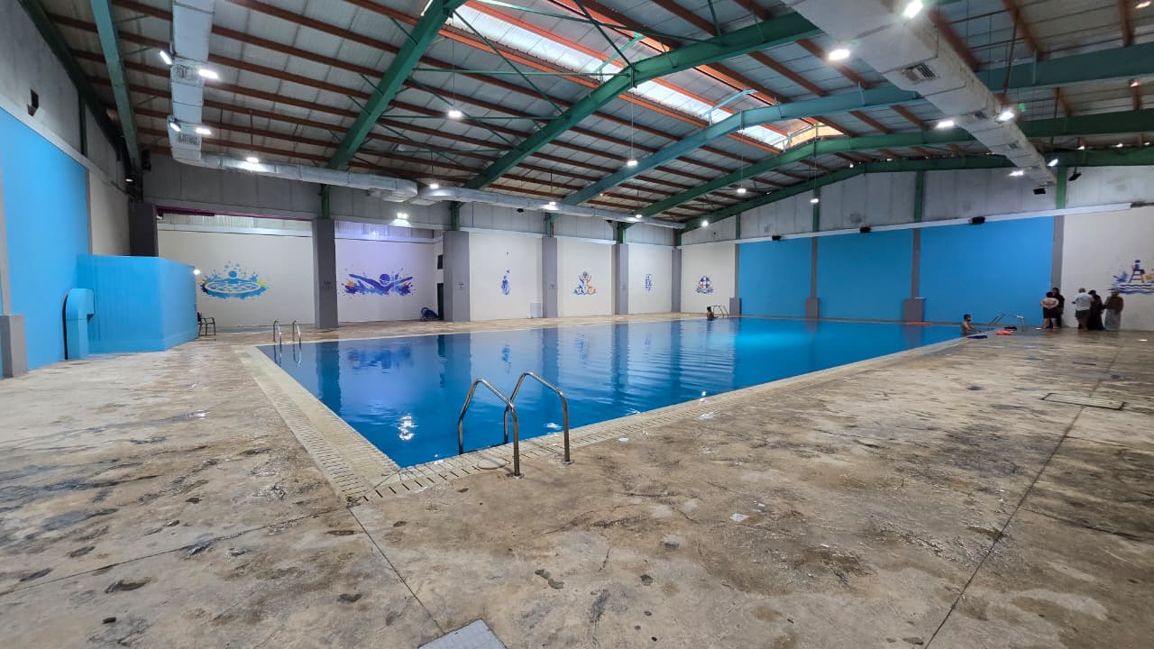 Swimming pool at Sanawbara surrounded by pine trees